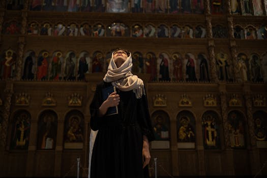 A woman with a headscarf looks up inside a church, holding a book.
